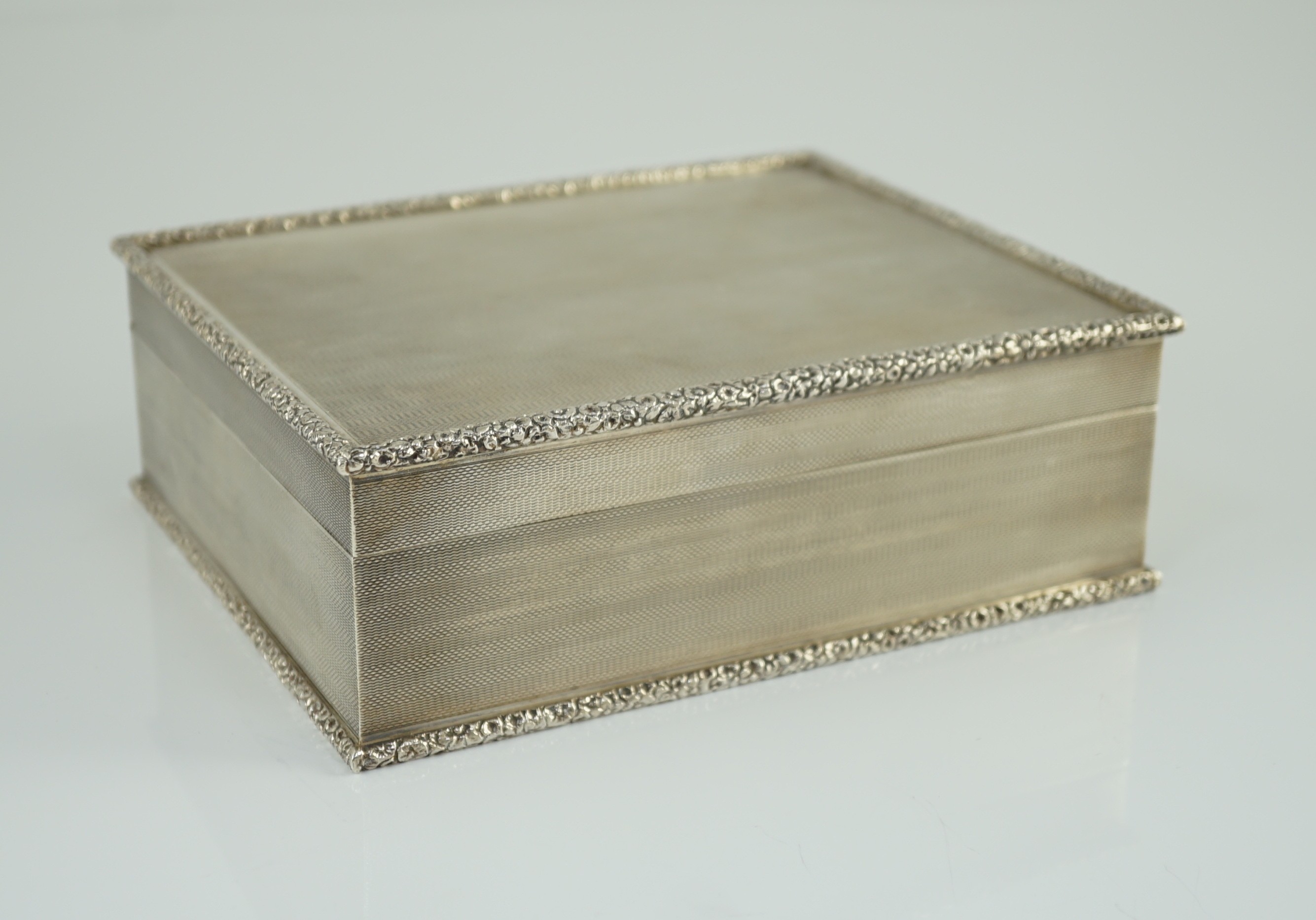 An Elizabeth II engine turned silver rectangular cigar box, by S.J. Rose & Son